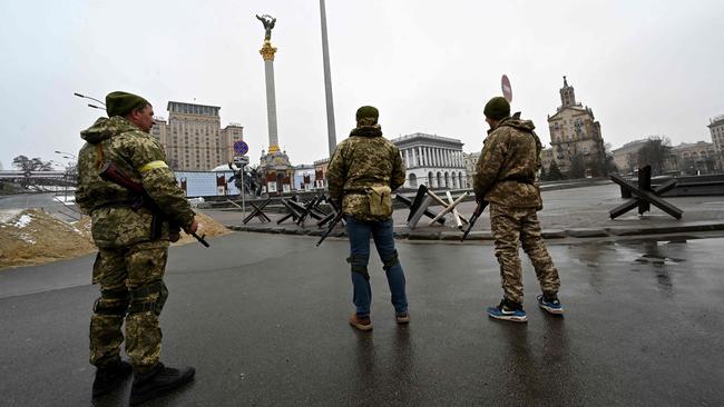 Ukrainian Territorial Defence Forces fighters stand guard in Independence Square in Kyiv. Picture: AFP