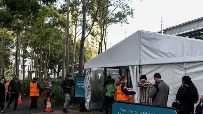 People line up to receive their COVID-19 vaccination at the NSW Health Vaccination hub in Sydney. Picture: NCA NewsWire/Bianca De Marchi.