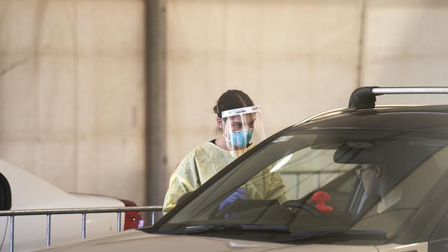 A nurse administers Covid tests at Bedford Park drive-through testing site. Picture: MATT LOXTON