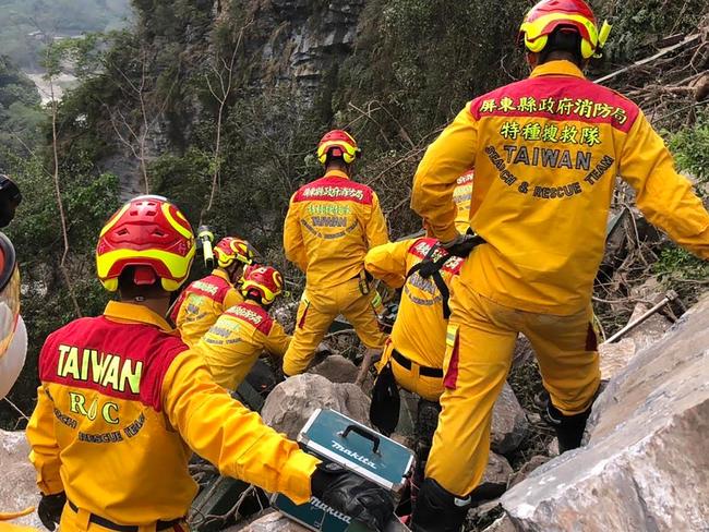 This handout from the Pingtung County Fire and Emergency Services taken and released on April 4, 2024, shows search and rescue personnel working on a mountainside during the search for the body of a hiker in Hualien, a day after a major earthquake hit Taiwan's east. Taiwan rescuers worked on April 4 to reach scores of people trapped in highway tunnels as engineers began a massive clear-up operation a day after the island's biggest earthquake in a quarter of a century. (Photo by Pingtung County Fire and Emergency Services / AFP) / -----EDITORS NOTE --- RESTRICTED TO EDITORIAL USE - MANDATORY CREDIT "AFP PHOTO / Pingtung County Fire and Emergency Services " - NO MARKETING - NO ADVERTISING CAMPAIGNS - DISTRIBUTED AS A SERVICE TO CLIENTS