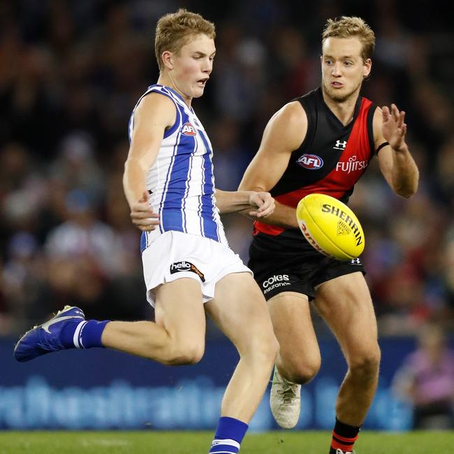 Tom Powell of the Kangaroos and Darcy Parish of the Bombers in action during the match between the Essendon Bombers and the North Melbourne Kangaroos at Marvel Stadium on Sunday. Picture: Michael Willson/AFL Photos via Getty Images