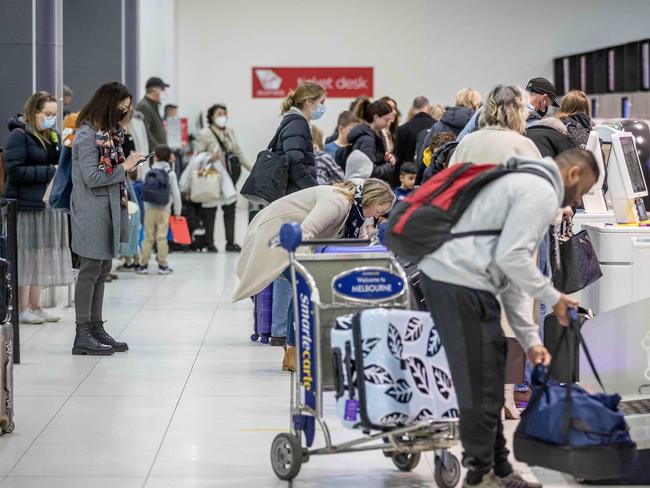 People move through the Virgin departure area at Melbourne Airport. Picture: Jake Nowakowski