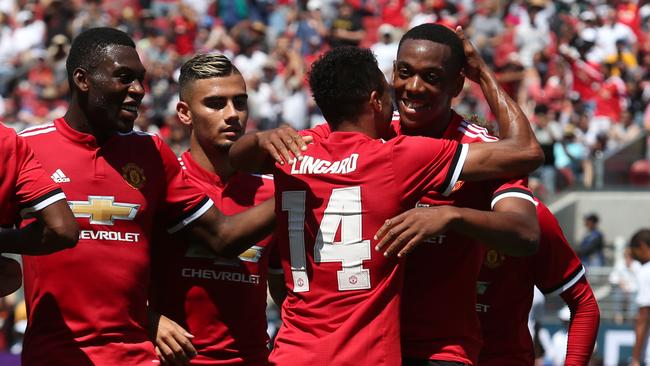 Manchester United forward Anthony Martial celebrates with Jesse Lingard.