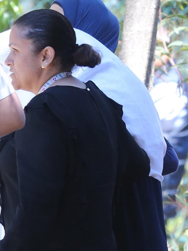 Maha Al-Shennag (right) covers her face with a blanket.