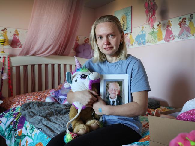 Yana Stevens sits on Olivia’s bed with a photo of her daughter surrounded by her favourite toys. Picture: David Caird