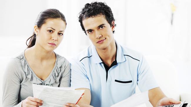 A stressed couple are working out how to manage their household bills in their home loan. Picture: iStock.