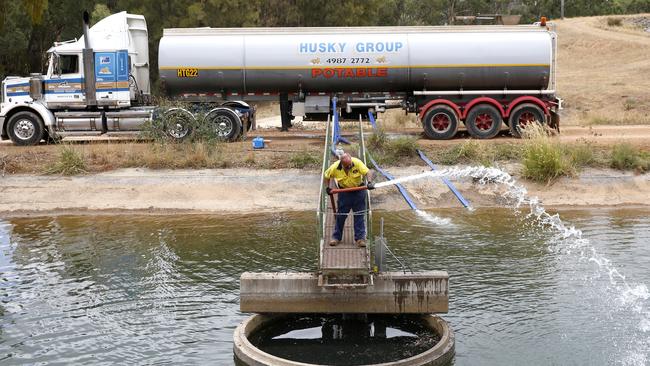 Husky Group Water contractor Mathew Byrne starts to empty 37,000 litres of fresh water into the makeshift Murrurundi reservoir. Picture: Peter Lorimer