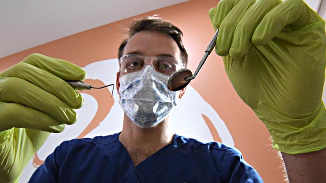 Dentist Tim Keys concerned at the number of kids needing their teeth removed.Tim is pictured working on a patient with healthy teeth.