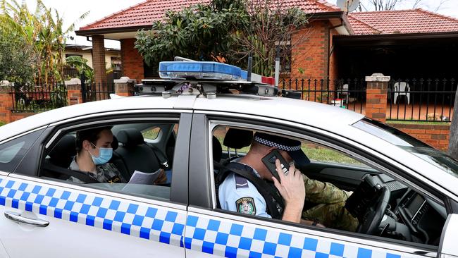 Members of the Australian Defence Force team up with NSW police officers to perform compliance checks on residents in lockdown in Yennora. Picture: Toby Zerna