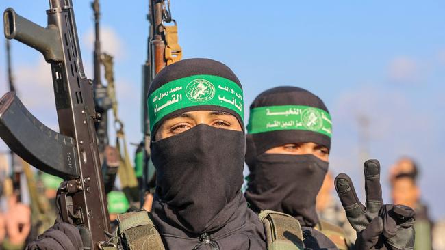 Palestinian militant group Hamas fighters secure an area before handing over an Israeli-American hostage to a Red Cross team in Gaza City on February 1. Picture: AFP