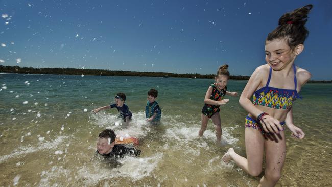 Melbourne visitors from the Broad and Levis families hit the beach at Noosaville. Picture: Mark Cranitch