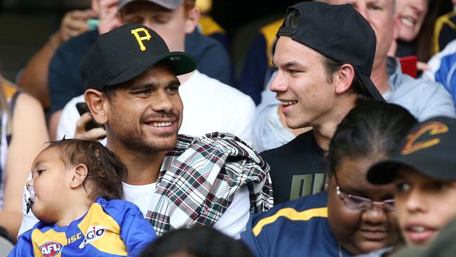 Cyril and Daniel Rioli watch on during Willie Rioli’s AFL debut. Picture: Michael Klein