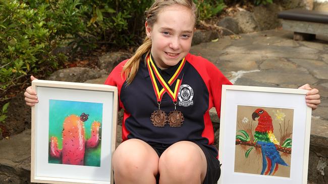 Tarah Cox, 10, with her colourful art pieces. Picture: Hamish Blair