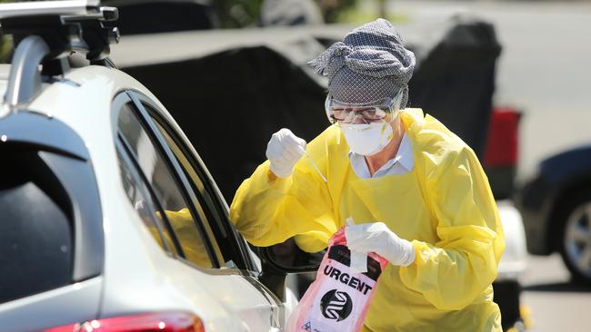 A doctor conductis a drive through COVID-19 test outside a GP in Maroubra, Sydney. Picture: Richard Dobson