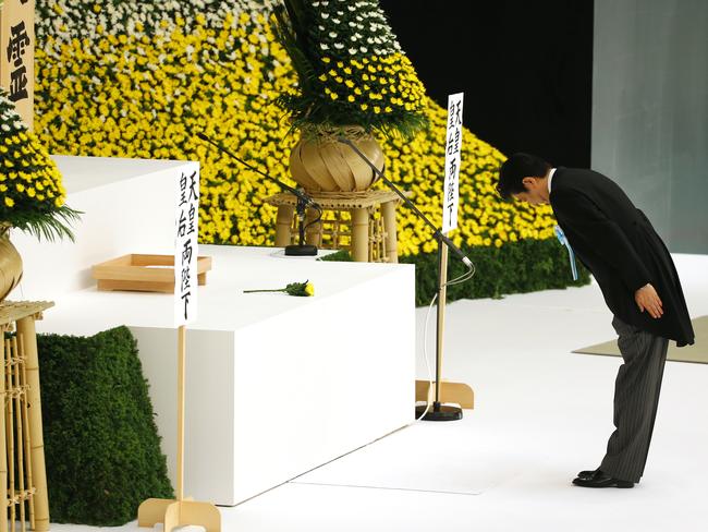 Controversial comments ... Japan’s PM Shinzo Abe bows before the main altar as he offers prayers for the war dead during a memorial service in Tokyo. Picture: AP