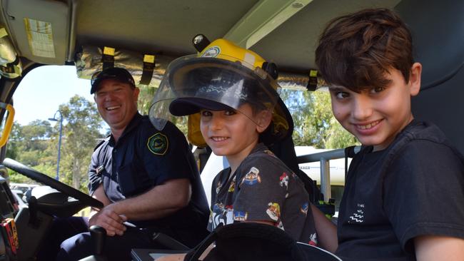 Darcy and Louis in the front of the fire truck