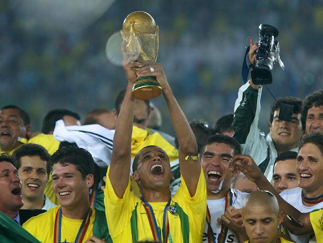 Rivaldo (C) lifts the World Cup trophy with teammates in 2002.