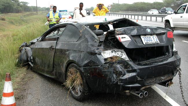 Journalists look at the crashed vehicle of Olympic champion sprinter Usain Bolt at the Vineyard Toll section of Highway 2000 in St. Catherine parish, Jamaica, 29 Apr 2009. Bolt was treated for minor injuries he received in the car crash on a rain-slicked highway. Bolt and an unidentified female passenger were taken to the hospital, though neither was seriously hurt, police Sergeant David Sheriff said.