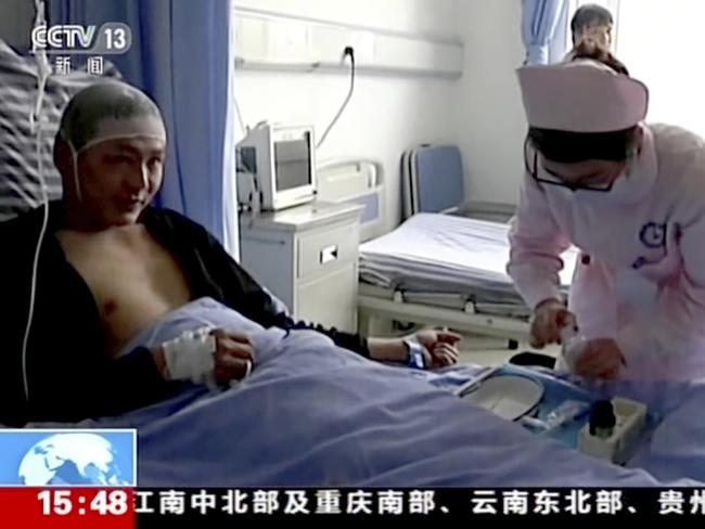 Qiao Dashuai, left, is attended to by nurses at a hospital after surviving a landslide in Xinmo village in Maoxian County in southwestern China's Sichuan Province.  Picture:  AP