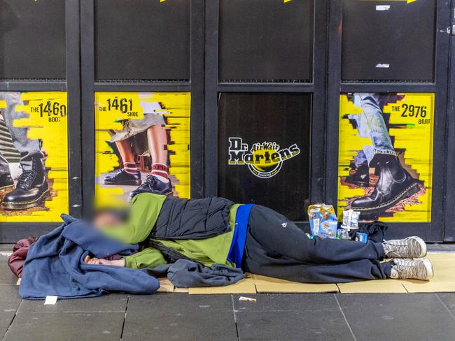 A man sleeps rough on Swanston St. Picture: Jake Nowakowski