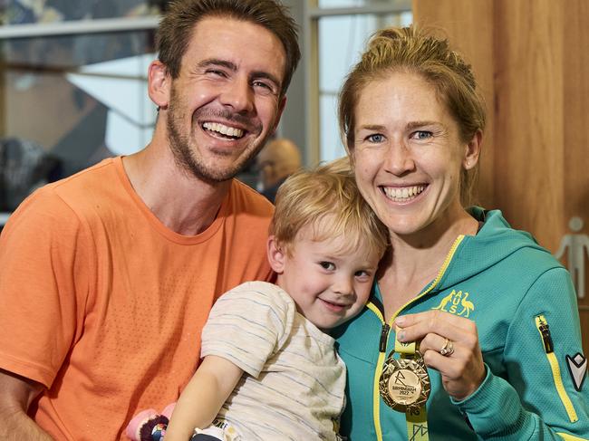 Dylan Stenson, Billy Stenson, 2, and Jess Stenson with her gold medal from the Commonwealth Games at Adelaide Airport, Friday, Aug. 5, 2022. Picture: MATT LOXTON