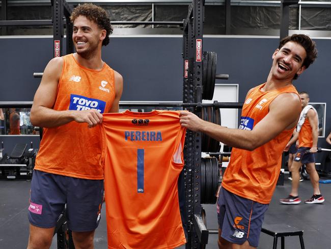 Jake Riccardi and Toby Bedford present Alex Pereira a GWS jersey in his absence. Picture: Sam Ruttyn