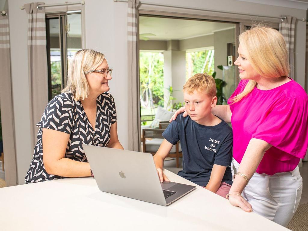 Project lead Professor Sonja March from the University of Southern Queensland gives Belinda Messer and her son Marshall a look at the new online platform Momentum (Photo: USQ/ Momentum)