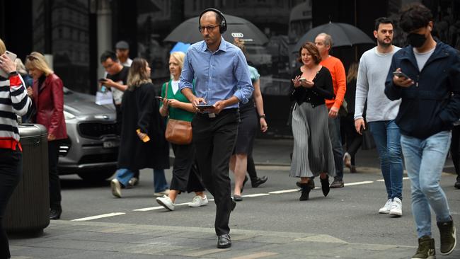 Pedestrians cross a busy street in the CBD of Sydney, NSW. Picture: NCA NewsWire / Steven Saphore