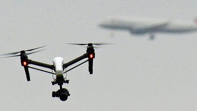 A drone flying in Hanworth Park in west London as a British Airways flight prepares to land at Heathrow Airport. Picture: Zuma Press