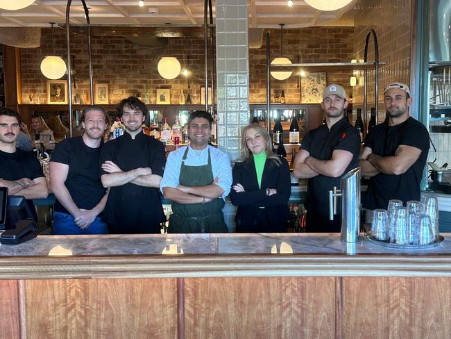 Tina Plessas (centre) owner of Cece's restaurant at the Coogee Diggers Club with staff at her restaurant on Sunday after she was granted interim orders last week to resume trading. Picture: Supplied.