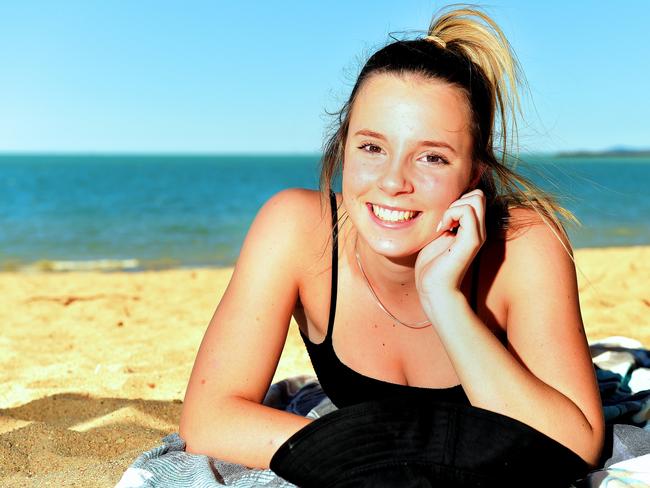 Mia Healey 14, on holidays from Moama, NSW, sunbakes on the Strand, Townsville.