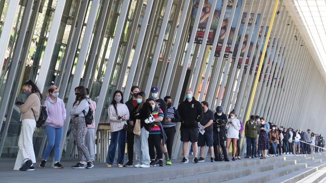 People line up to get their Covid vaccinations at the Melbourne Exhibition Centre. Picture: NCA NewsWire / David Crosling