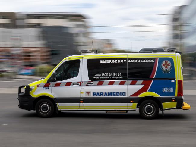 MELBOURNE, AUSTRALIA - NewsWire Photos FEBRUARY 13, 2022: An ambulance speeds away from the Royal Melbourne Hospital. Ambulance, Generic.Picture: NCA NewsWire / David Geraghty