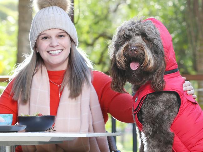 Embargoed for The Saturday TelegraphAmelia Perry with dog Otis, wearing a DOGUE winter coat. Pictured at Storehouse on the Park @ Vibe Rushcutters Bay. Keeping warm now that winter has finally arrived. Picture Rohan Kelly.