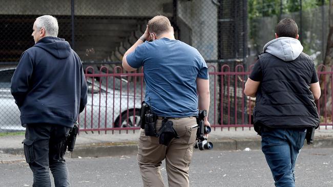 Undercover police with binoculars outside Richmond West Primary School. Picture: Nicole Garmston