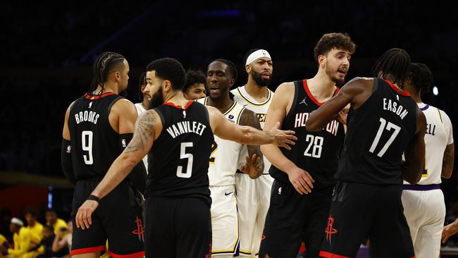 Referee J.T. Orr, left, assesses technical fouls to Houston Rockets head coach Ime Udoka, center, and Los Angeles Lakers forward LeBron James. Picture: Getty