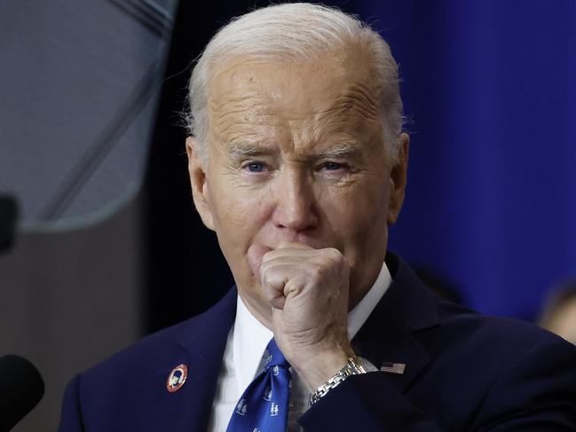 WASHINGTON, DC - DECEMBER 16: U.S. President Joe Biden coughs as he delivers remarks at the Department of Labor on December 16, 2024 in Washington, DC. Biden signed a proclamation to establish the Frances Perkins National Monument in Maine. Perkins was the first female Cabinet secretary and served as the Labor Secretary under Franklin Roosevelt.   Kevin Dietsch/Getty Images/AFP (Photo by Kevin Dietsch / GETTY IMAGES NORTH AMERICA / Getty Images via AFP)