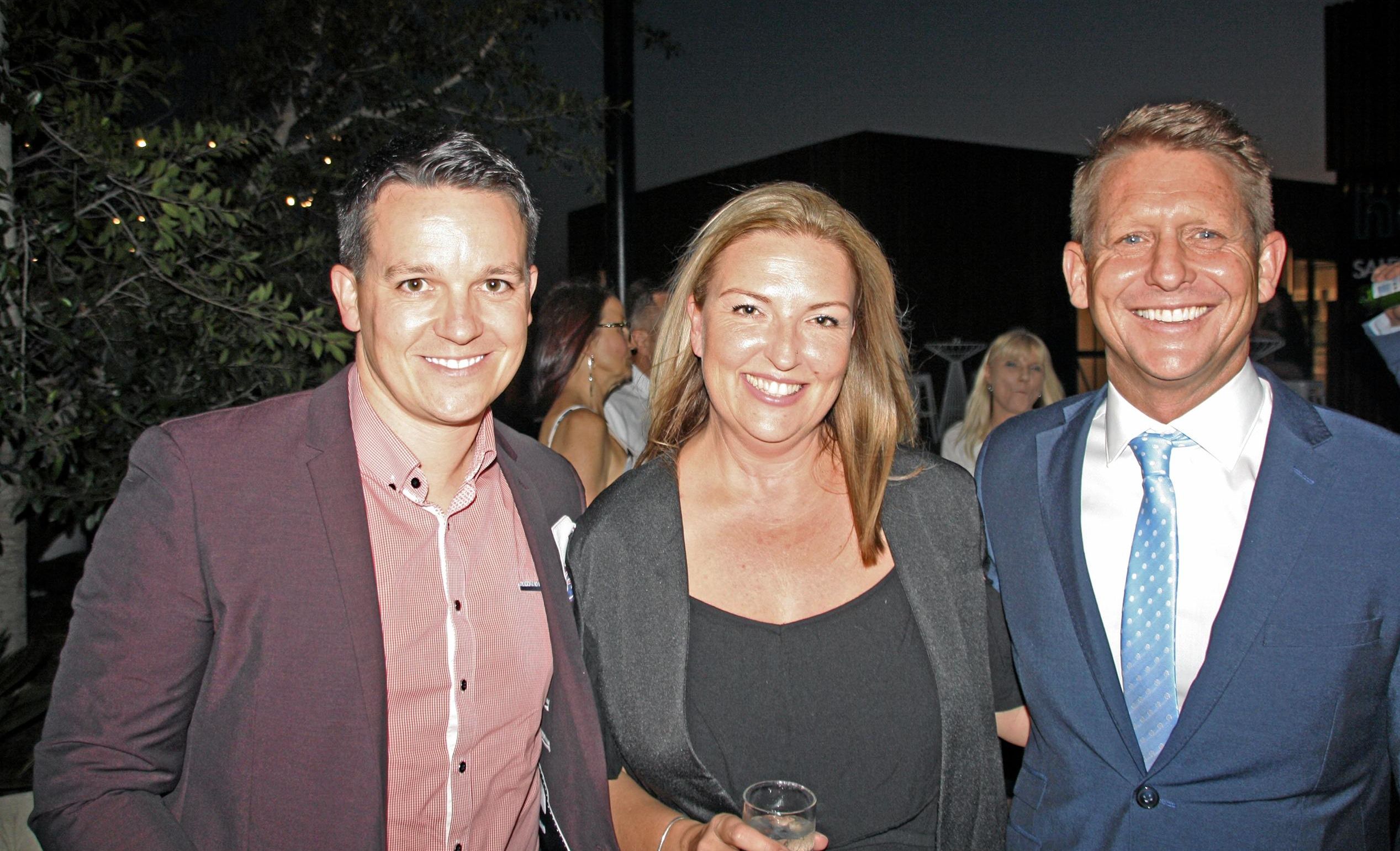 Gary Burkert and Melissa Wolfe of Plantation Homes with Andrew Boulding of Metricon at AVID Property Group's launch of its new sales and information centre in Palmview's master-planned community of Harmony. Picture: Erle Levey