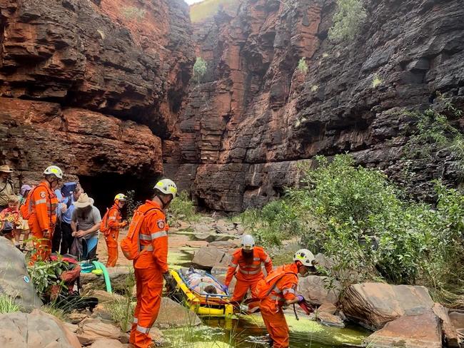 Rescue crews careen a steep cliff to get the bitten mother to safety. Picture: DFES WA