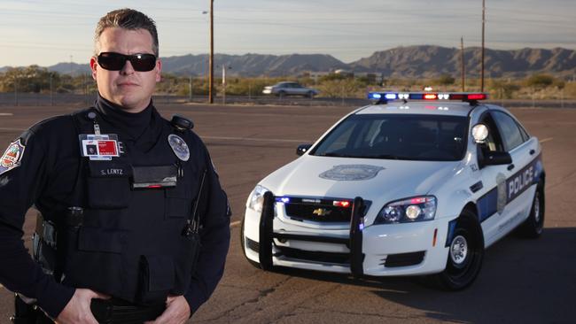 As American as a meat pie and sauce: Arizona police officer Sergeant Steve Lentz evaluates a 2010 Chevrolet Caprice PPV, a slightly altered Holden Commodore. Picture: News Corp Australia.