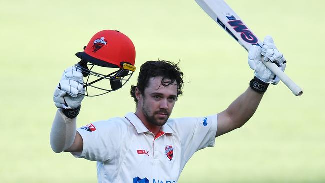 Travis Head of the Redbacks raises his bat after scoring 100 runs during the Marsh Sheffield Shield match between South Australia and New South Wales at Adelaide Oval in Adelaide, Saturday, November 2, 2019. (AAP Image/David Mariuz)