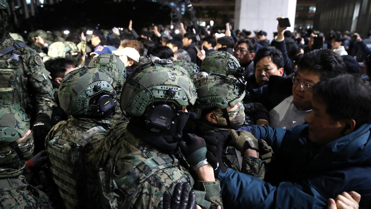 South Korean soldiers try get into the national assembly on December 04, 2024 in Seoul. Picture: Chung Sung-Jun/Getty