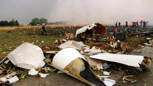 Rescue workers inspect debris from the crash. Picture: Getty