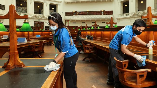 Cleaners sanitising the State Library of Victoria. Picture: Ian Currie