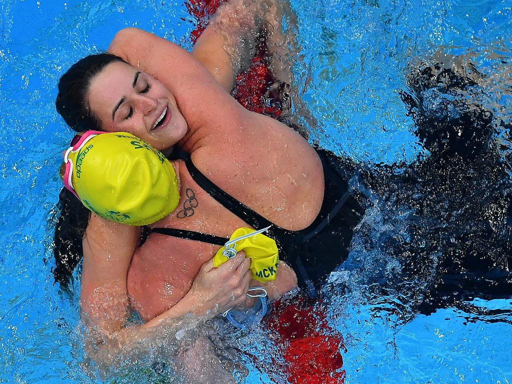 Kaylee McKeown gets a congratulatory hug from Australian teammate Emily Seebohm after they won gold and bronze respectively in the Women’s 100m backstroke. Picture: Francois-Xavier Marit/AFP