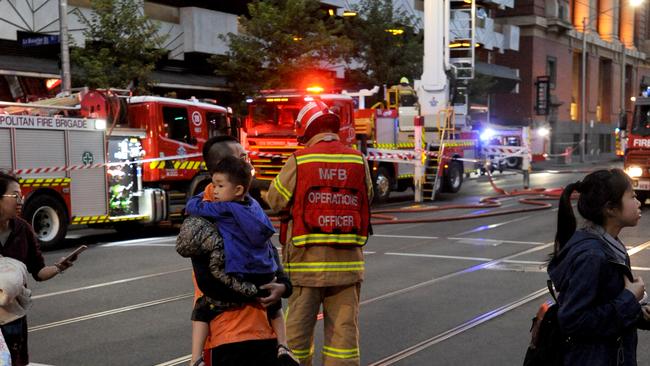 Residents flee the blaze. Picture: Andrew Henshaw