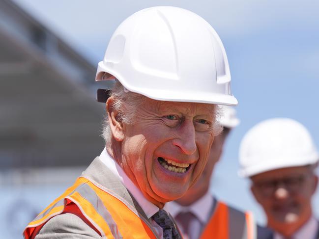 SYDNEY, AUSTRALIA – NewsWire Photos OCTOBER 22, 2024: Britain's King Charles III wears a protective hat as he visits the Homes NSW Cowper Street development in Sydney, Tuesday, October 22, 2024. King Charles III and Queen Camilla are visiting Australia from 18 October to 23 October. NewsWire / POOL / MARK BAKER