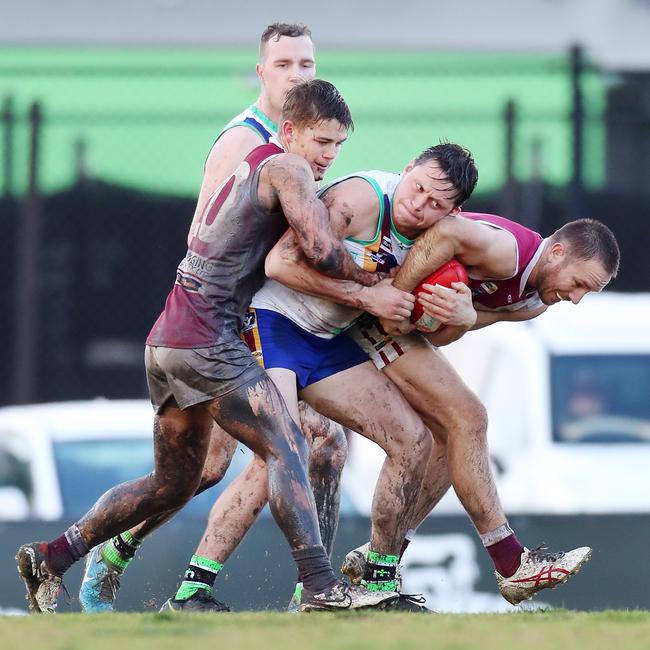 Moe’s Tyler Pratt is sandwiched between two Traralgon opponents.