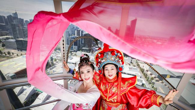 Traditional dancers Eva Zhang and Qiaolan Jin ride the Melbourne Star ahead of Chinese New Year celebrations. Picture: Nicole Cleary