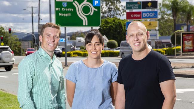 Federal MP for Ryan, Julian Simmonds, at the Moggill Road/Brookfield Road roundabout with local residents Emma and Mark Pascoe in April last year. Mr Simmonds secured millions in funding to upgrade the roundabout. Picture: AAP/Richard Walker